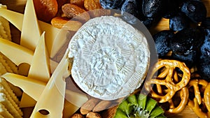 A close-up picture of cheese and dried fruits