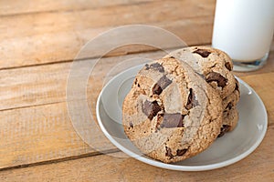 Close up picture of chocolate cookies and milk