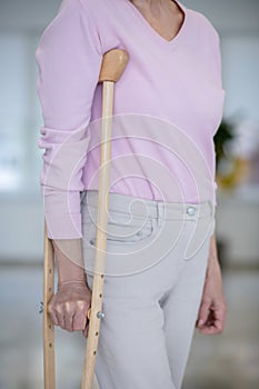 Close up picture of elderly woman with a crutch