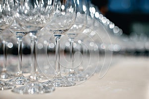 Close up picture of empty glasses on the beige tablecloth