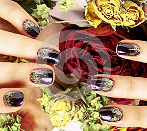 Close up picture of manicure nails with dry flower red rose, deh