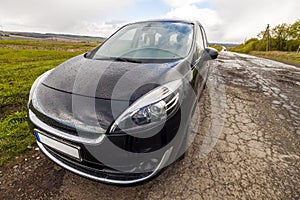 Close-up picture of a modern car on a bad road