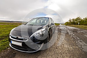 Close-up picture of a modern car on a bad road