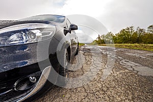 Close-up picture of a modern car on a bad road