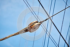 Close up picture of old sailing ship wooden pulley.