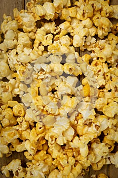 A close-up picture of popcorn placed on a plank.