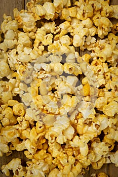 A close-up picture of popcorn placed on a plank.