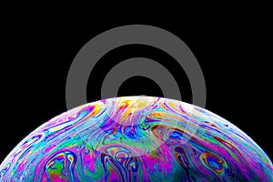 Close up picture of soap bubble on black background like planet abstract multicolor psychedelic globe