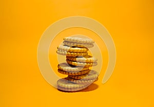 Close up picture stack of cookies isolated in oarange background