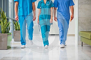 Close up picture of three doctors walking in the corridor