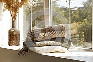 Close up picture of warm clothes and blanket. Winter and autumn concept.