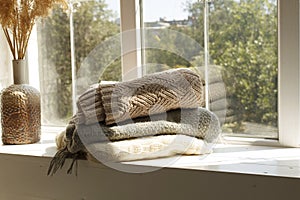 Close up picture of warm clothes and blanket. Winter and autumn concept.