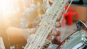 Close-up pictures of musicians playing  Baritone Saxophone  In the music practice room, blurred background