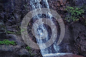 Close-up of a picturesque waterfall cascading down a gorgeous mountain