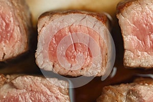 A close up of a piece of meat with the pink part showing