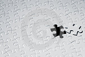 Close up piece of white jigsaw puzzle