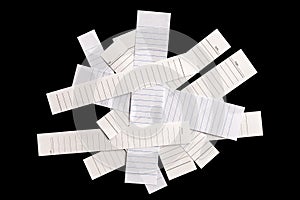 Close up piece of white lined paper isolated on black