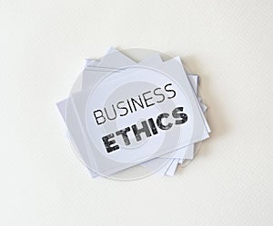 Close up piece of white paper card with word of Business Ethics , a concept of a business core value and moral