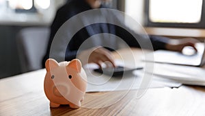 Close up of piggybank on wooden table