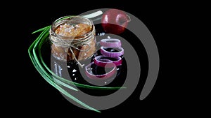 Close up pike caviar in jar, Delicious caviar, roe purple onion cut into rings Isolated on a black background, Flat lay. Copy spac