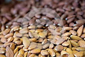 Close up for pile of almond nuts as whole background