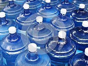 Close up pile of big drinking water bottles