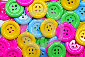 Close up of a pile of buttons of many colors