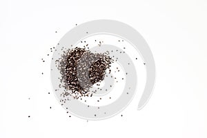 Close up of a pile of chia seeds Salvia hispanica on a white isolated background.