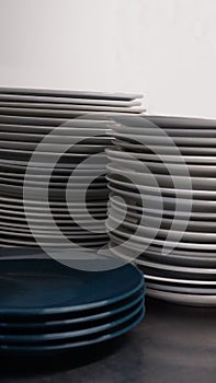 Close-up of pile of clean plates. Stack of dishes. Pieces of white and blue ceramic plate