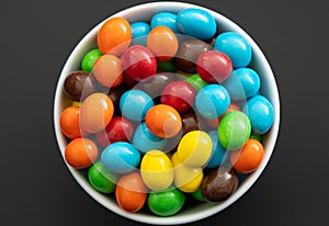 Close up of a pile of colorful chocolate coated candy, chocolate background photo