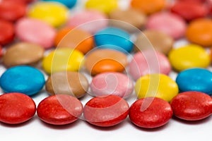 Close up of a pile of colorful chocolate coated candy, chocolate pattern, chocolate background.