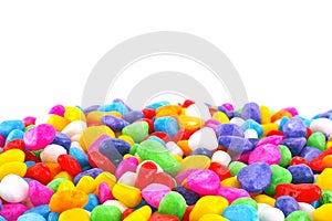 Close up pile of colorful stones isolated on white background