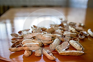 Close-up of a pile of finished peanut shells on the dining table