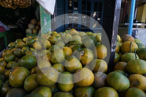 Close up of a pile of fresh local citrus fruits in a fruit basket in a traditional fruit shop for sale