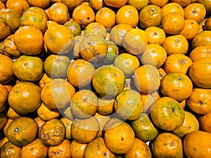 Close-up pile of Fresh oranges fruit (Sai Nam Phueng) or Tangerine orange in Thailand