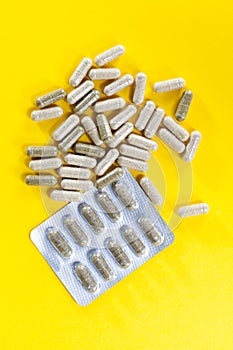 Close-up pile of green-white color medical pills on white background