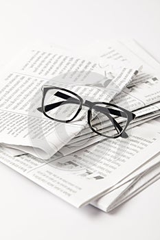 close up of pile of newspapers and eyesight, on white