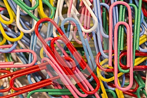 A close up of a pile of paper clips