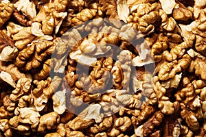 Close-up of a pile of peeled walnut kernels, top view. General view