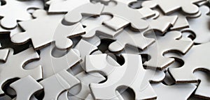Close-up of a pile of uncompleted elements of a white puzzle. A huge number of rectangular pieces from one large white mosaic