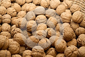 Close up of a pile of walnuts in a basket.