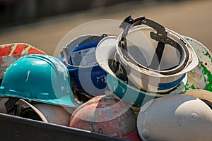 Close-up of Piled Hardhats on Sunny Day