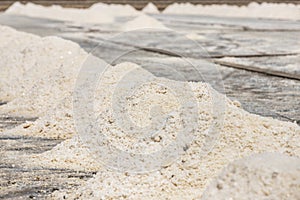 Close up piles of raw white sea salt in the salt farm