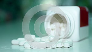 Close up of pills or caplets spinning on a table shot from above