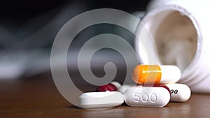 Close up of pills or caplets spinning on a table shot from above