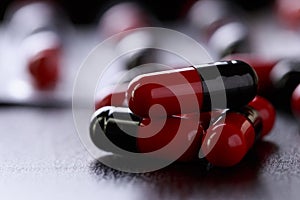 Close-up Pills red anf black on Tablets. Medical background
