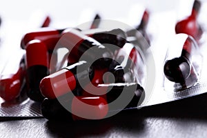 Close-up Pills red anf black on Tablets. Medical background