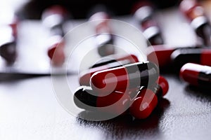 Close-up Pills red anf black on Tablets. Medical background