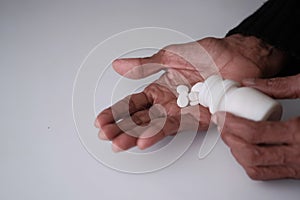 Close up of pills on senior women hand