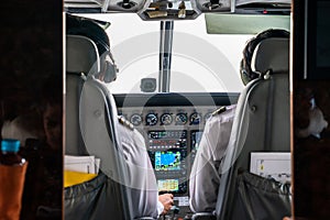 Close up 2 pilots concentrate drive the small private jetplane on the sky photo